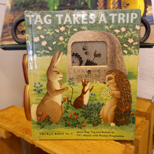 Cover of Tag Takes a Trip with turning wheel TV window – vintage Rag, Tag and Bobtail children's book