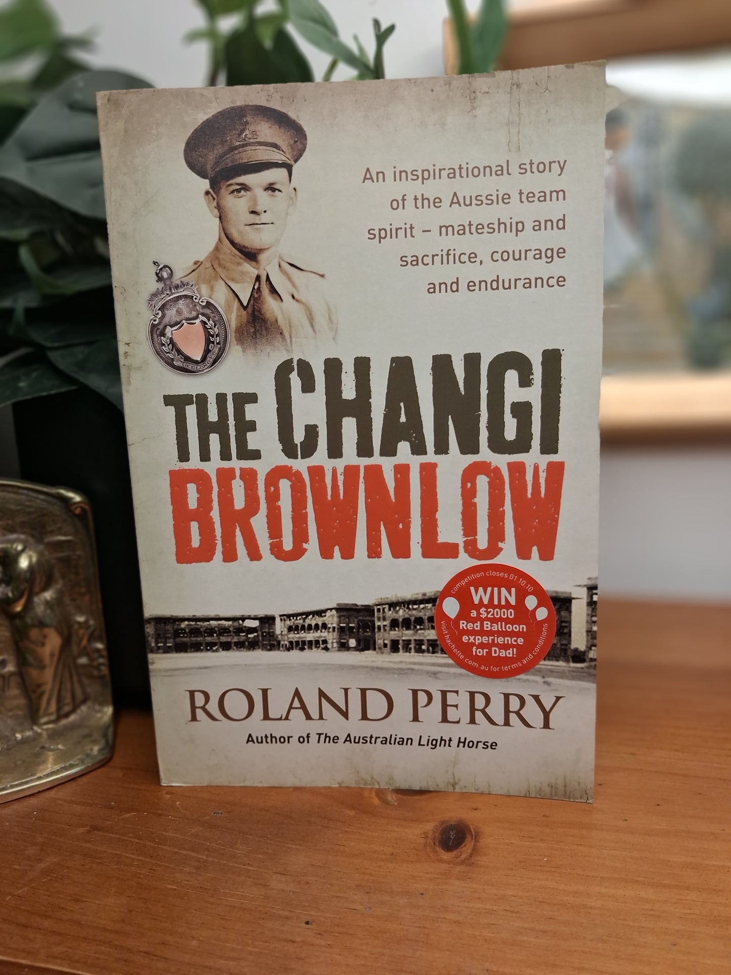 Cover of The Changi Brownlow by Roland Perry, a World War II history of Australian prisoners of war and football in Changi.